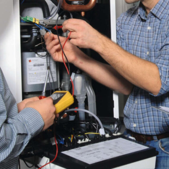 Photo of a Chris Jones Plumbing & Heating engineer carrying out maintenance on a boiler